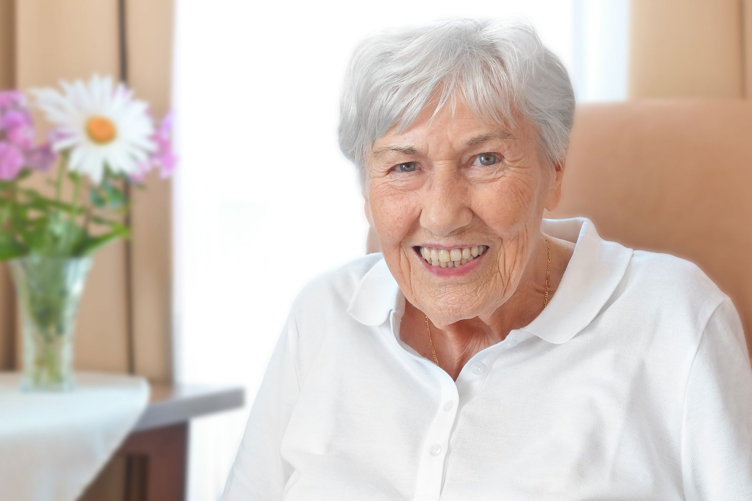 Smiling elderly woman sitting on couch