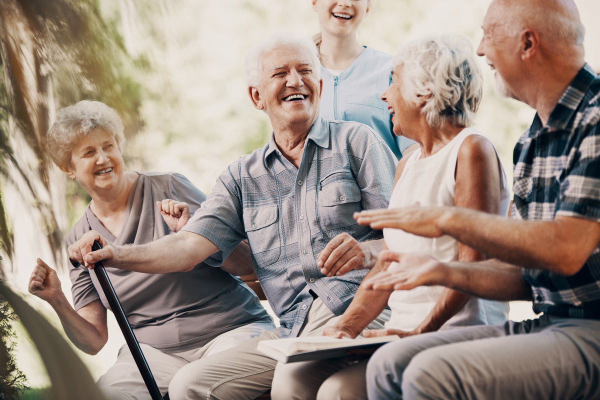 Seniors Sitting Outside Laughing at Nanaimo VRS Retirement Community