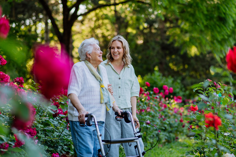 Senior safely walking outside with a walker at a senior independent or assisted living community in Nanaimo